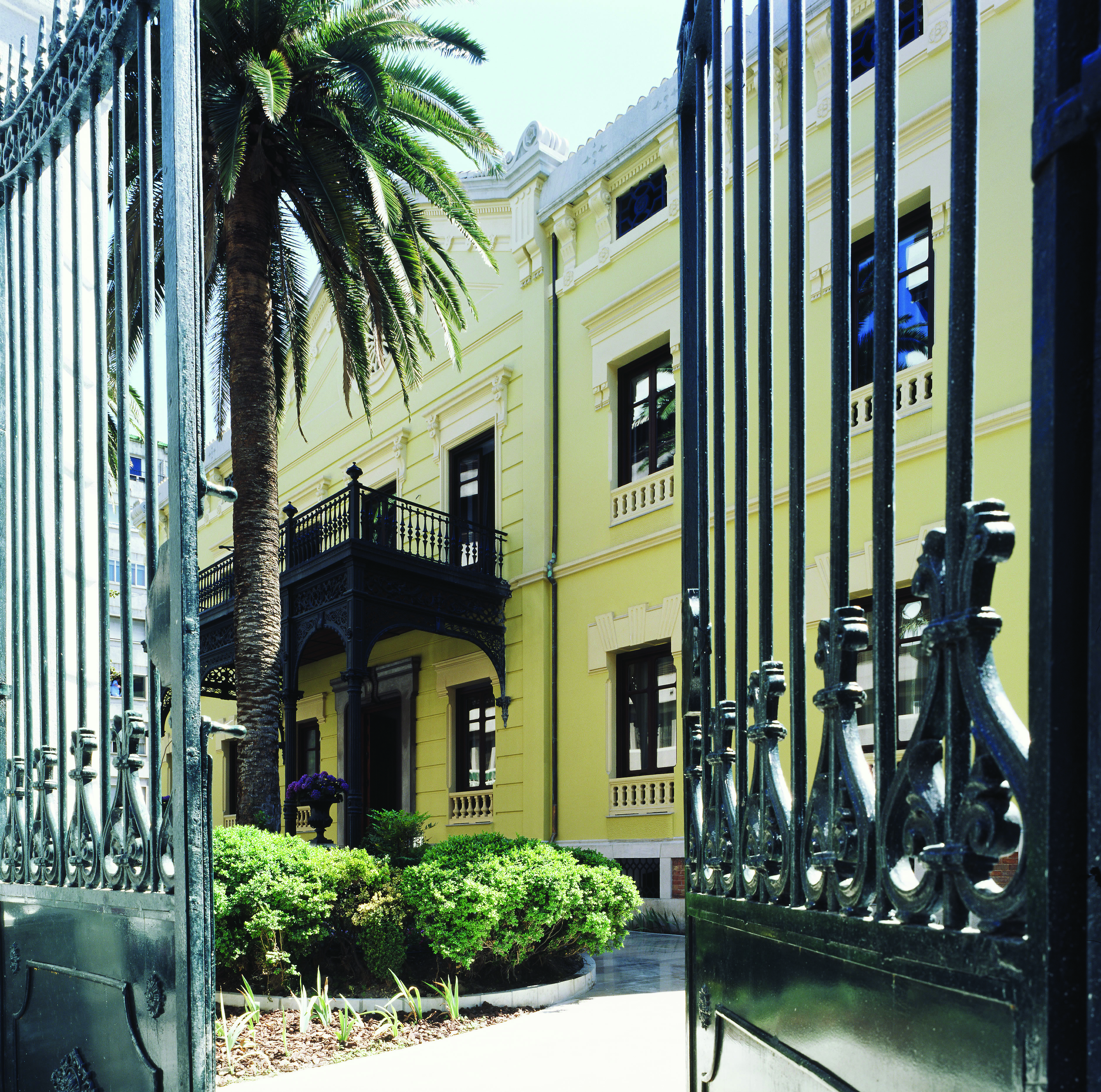 Palacio de los Patos Granada entrance yellow building iron gates balcony