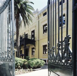 Palacio de los Patos Granada entrance yellow building iron gates balcony