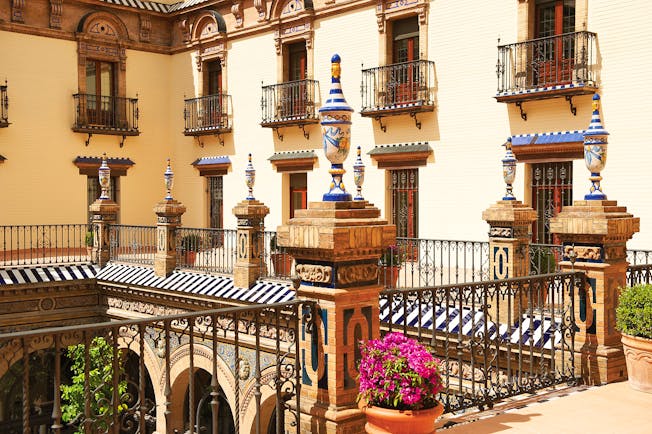 Courtyard with balcony surrounding and potted plants and flowers 