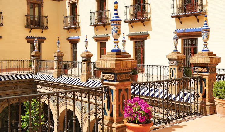 Courtyard with balcony surrounding and potted plants and flowers