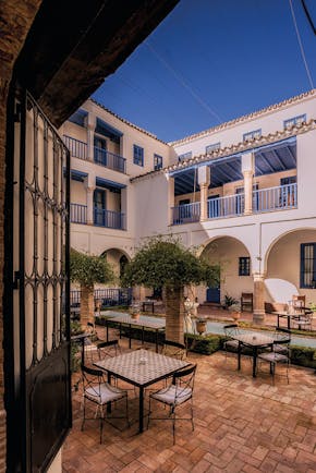 Las Casas de la Juderia Andalucia courtyard outdoor seating area plants and shrubbery