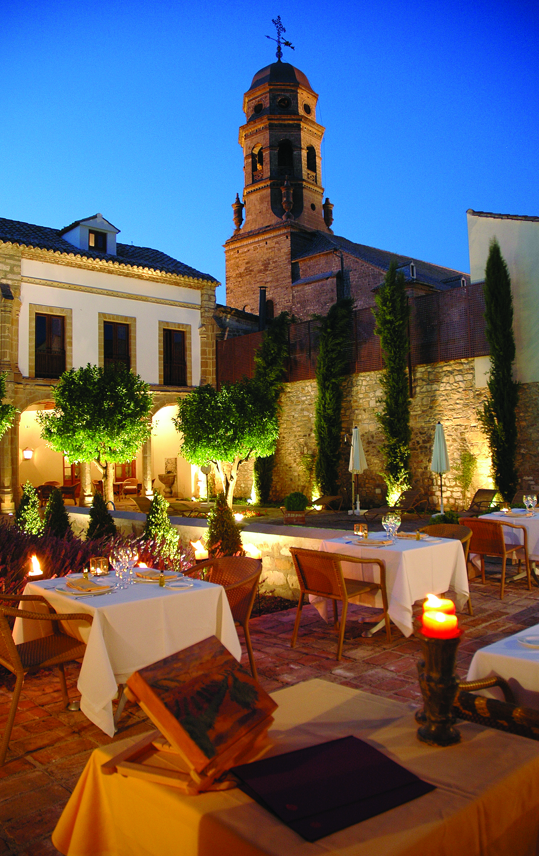 Hotel Puerta de la Luna Andalucia outdoor dining at night terrace trees candle lights
