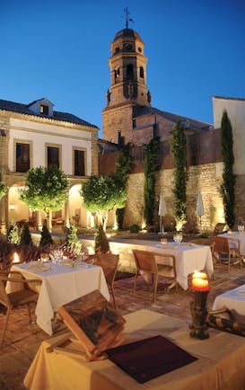 Hotel Puerta de la Luna Andalucia outdoor dining at night terrace trees candle lights