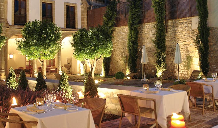 Hotel Puerta de la Luna Andalucia outdoor dining at night terrace trees candle lights
