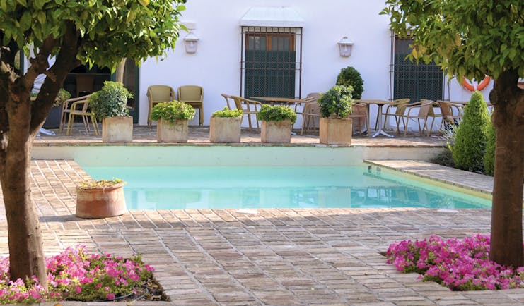 Hotel Puerta de la Luna Andalucia pool seating wicker chairs trees