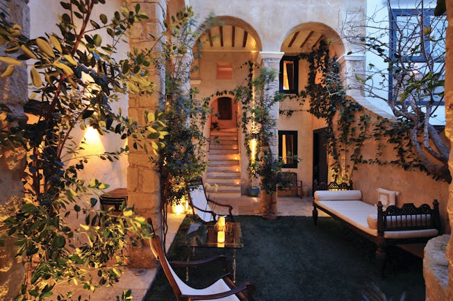 Hotel V Andalucia courtyard outside seating area trees vines stone walls