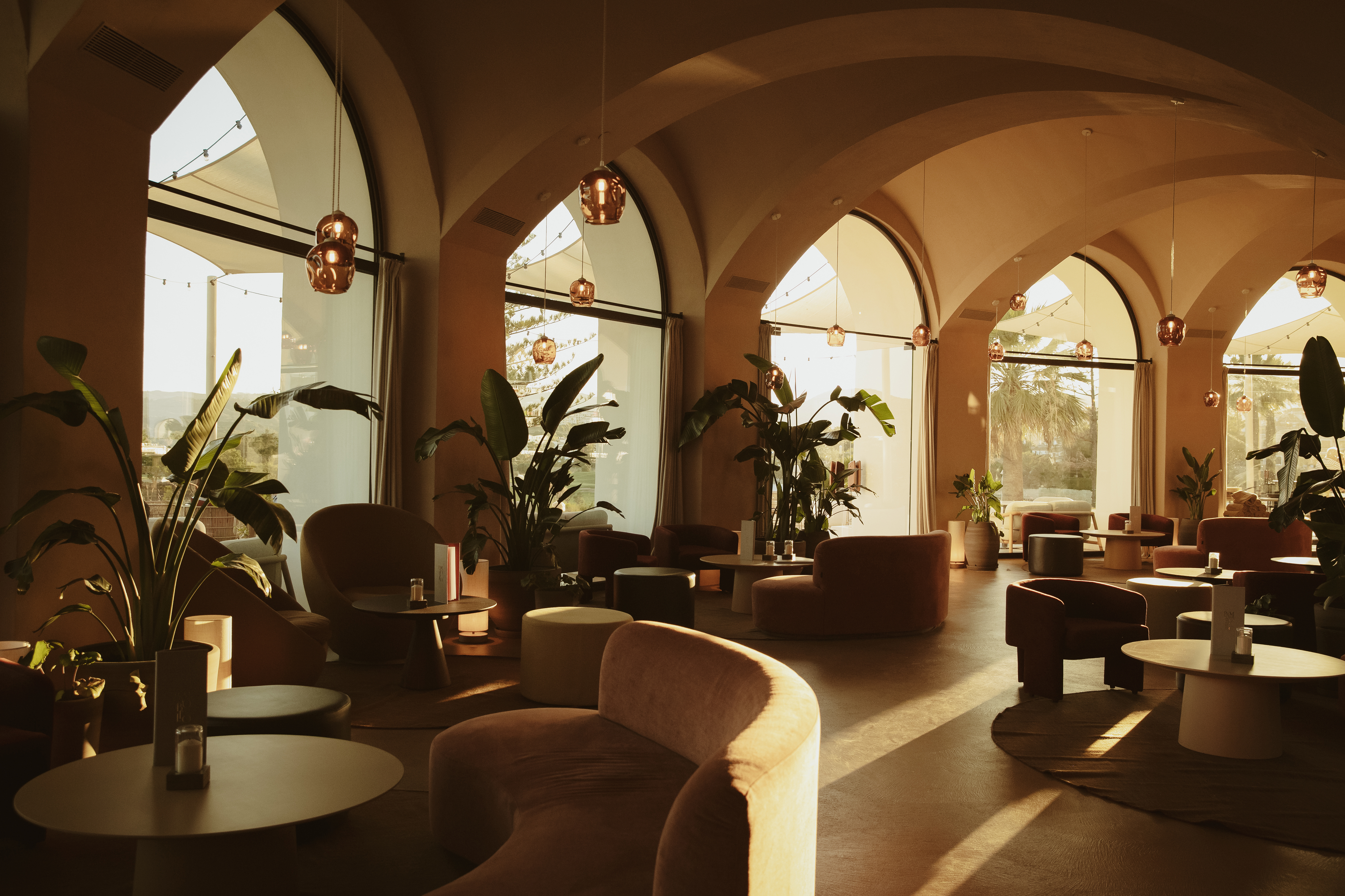 La Zambra Resort Bamboleo Restaurant interior with arched windows and sofa-style seating