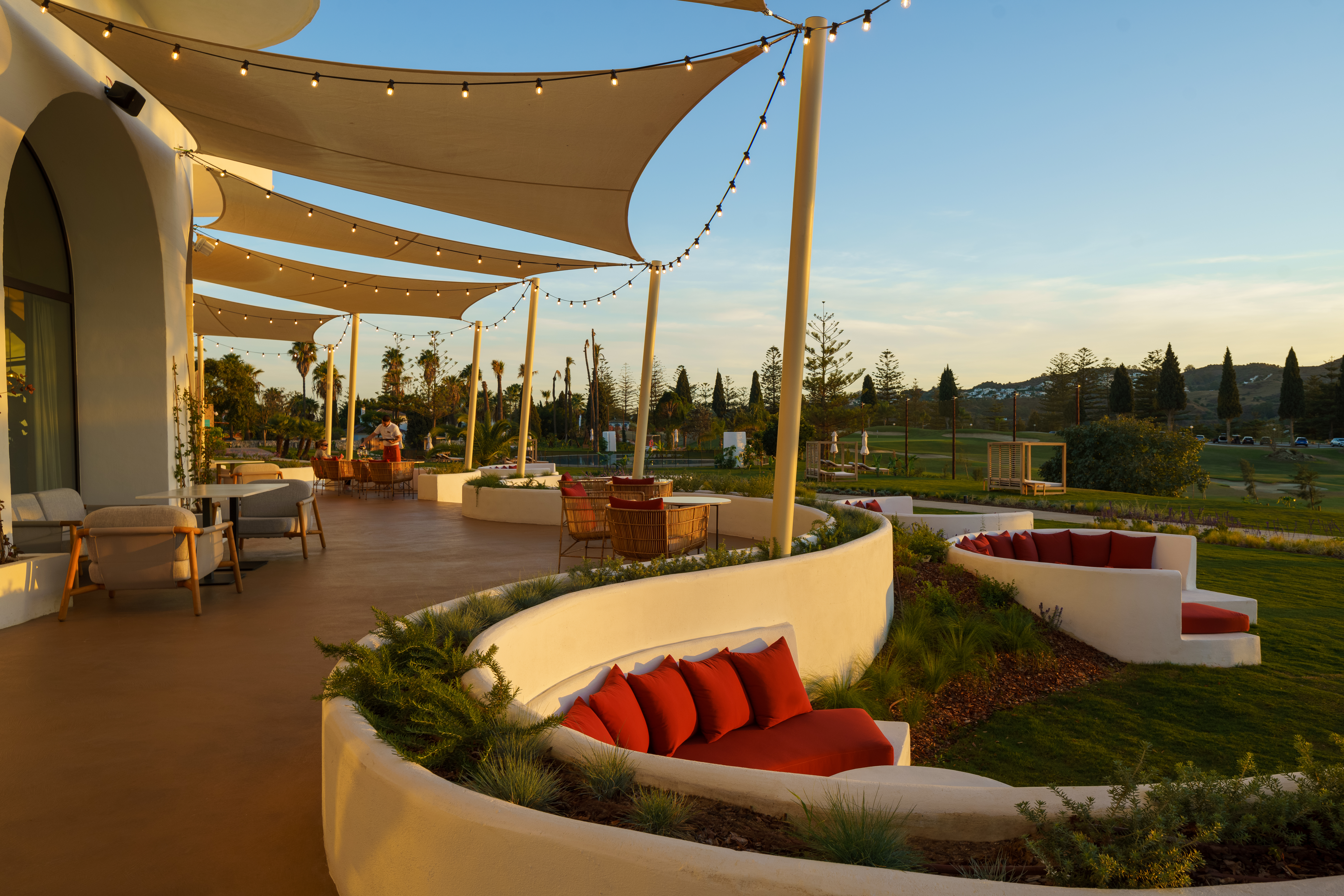 La Zambra Resort Bamboleo Restaurant terrace with low curving walls and sails sheltering the dining tables
