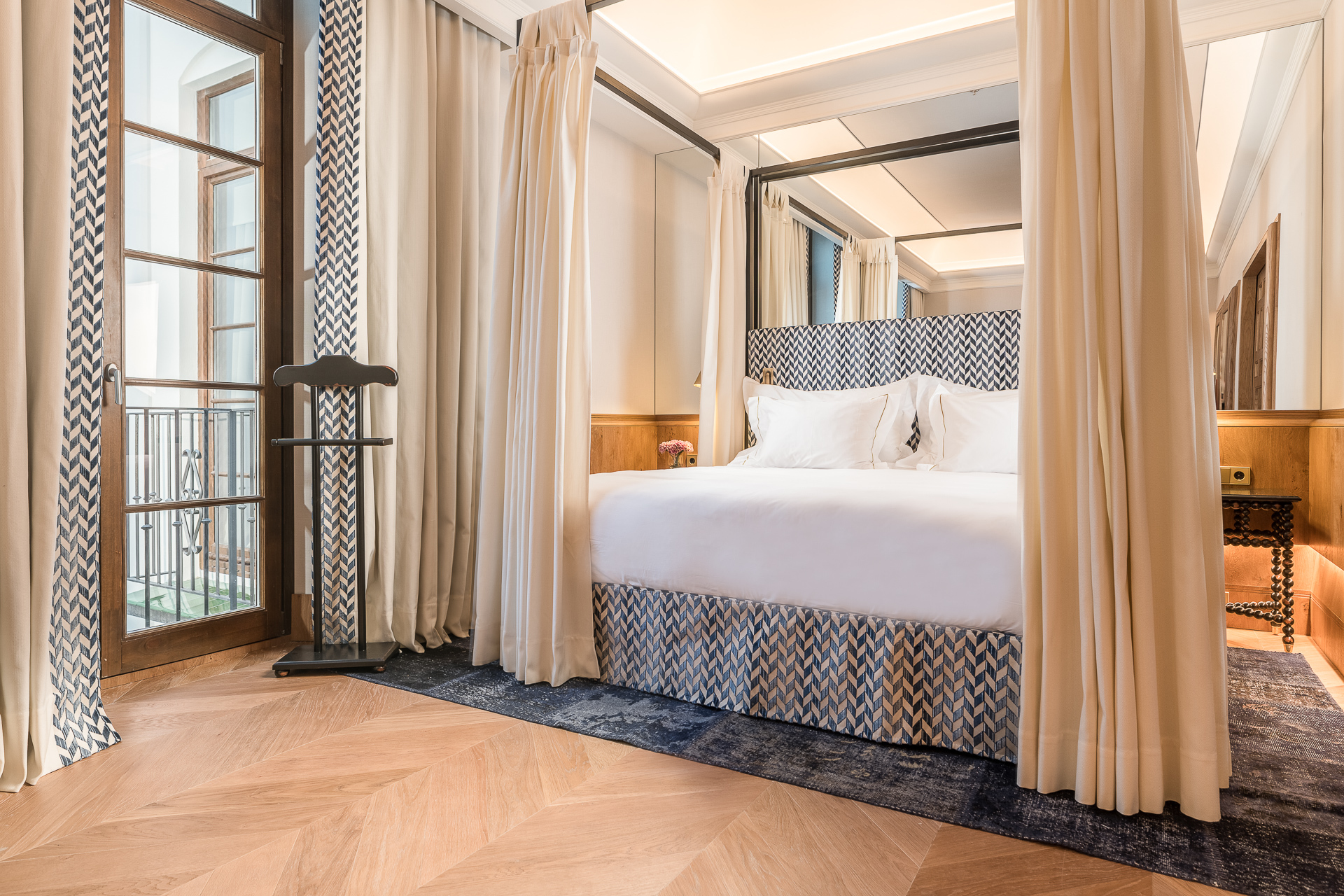 Palacio Solecio Deluxe Palacio room, with four-poster bed, neutral colour scheme, and floor-to-ceiling windows