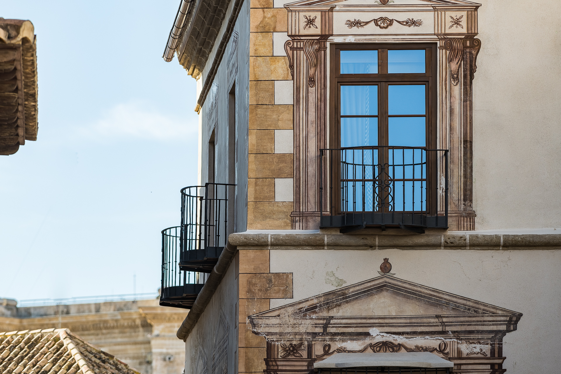 Palacio Solecio authentic facade with juliet balconies, tall windows, and decorative window frames
