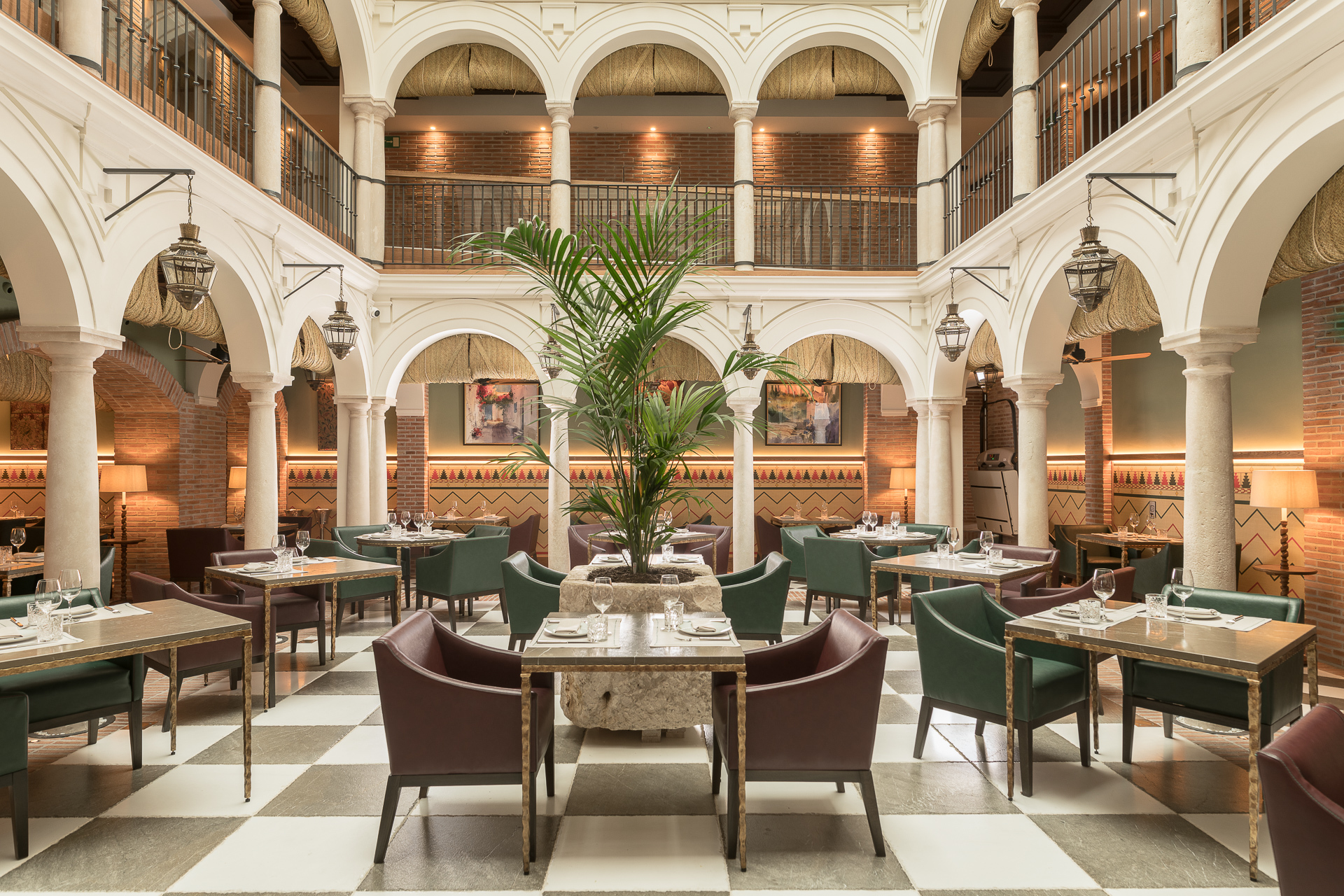 Palacio Solecio Balausta Restaurant with high ceilings, archways on two-storys, forming an inner courtyard