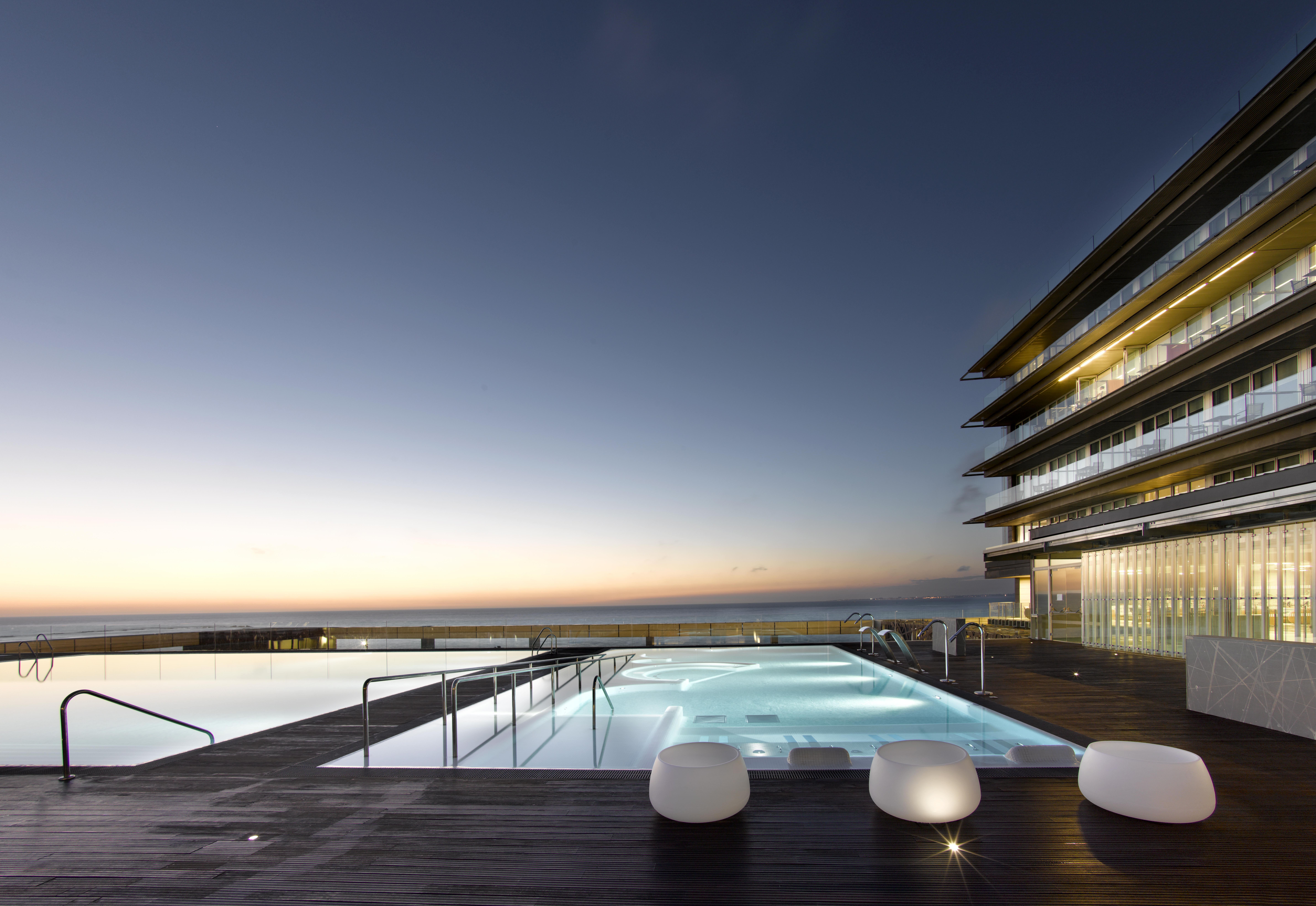 Parador de Cadiz Hotel Atlantico poolside, decking, pool lit up at night, terrace overlooking sea