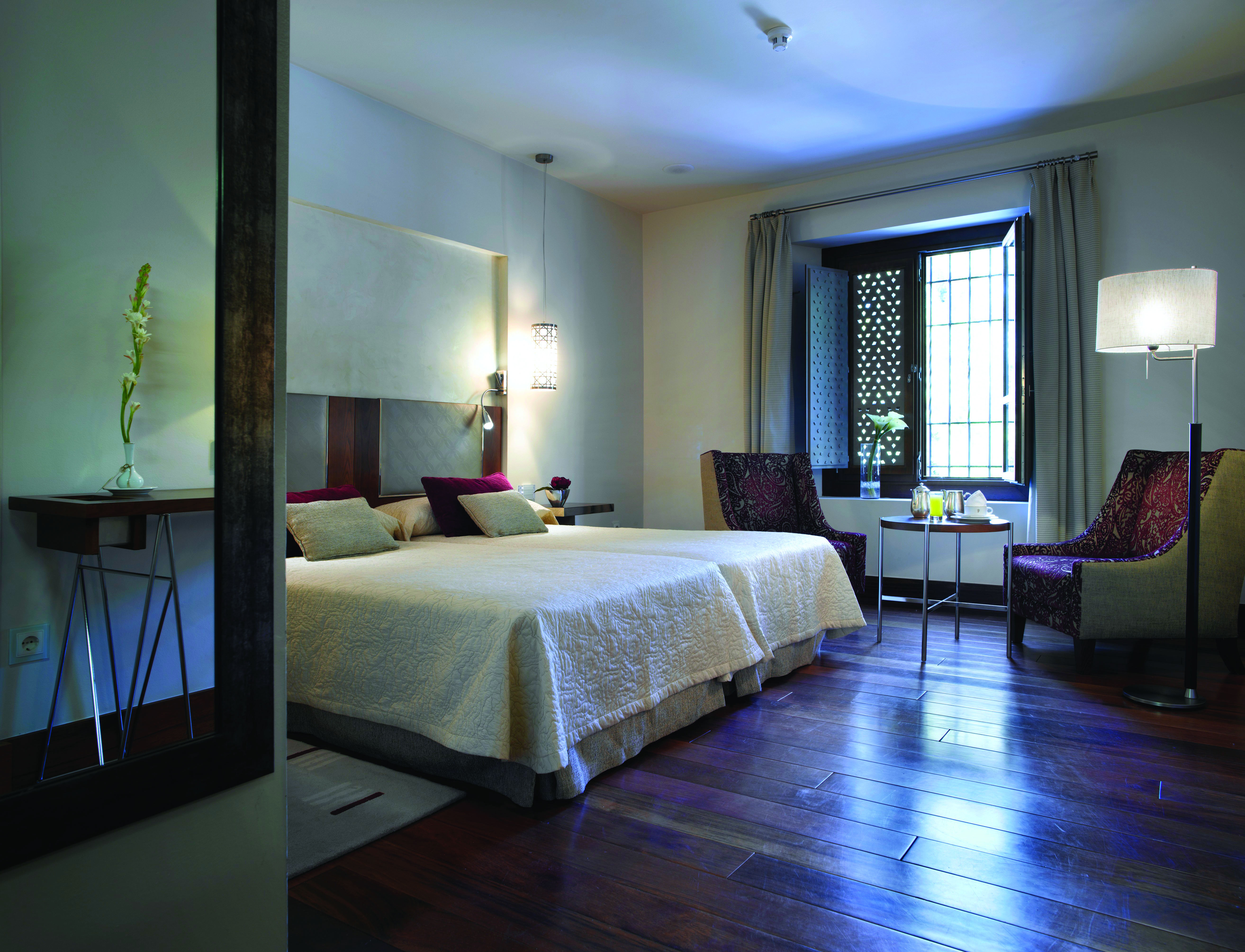 Parador de Granada guest room bed chairs modern décor