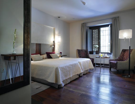 Parador de Granada guest room bed chairs modern décor