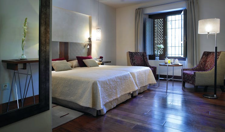 Parador de Granada guest room bed chairs modern décor