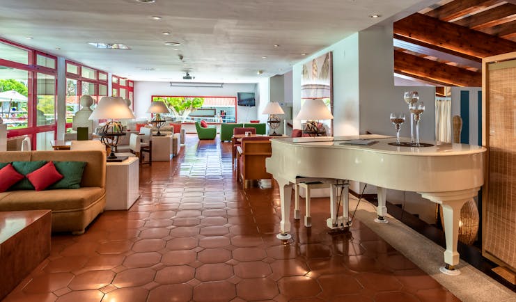 Parador de Nerja bar, baby grand piano, sofas, tiled floor