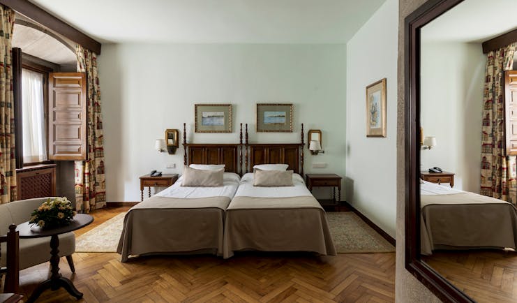 Parador de Pontevedra standard room, twin beds, wooden floors, shuttered windows, traditional decor