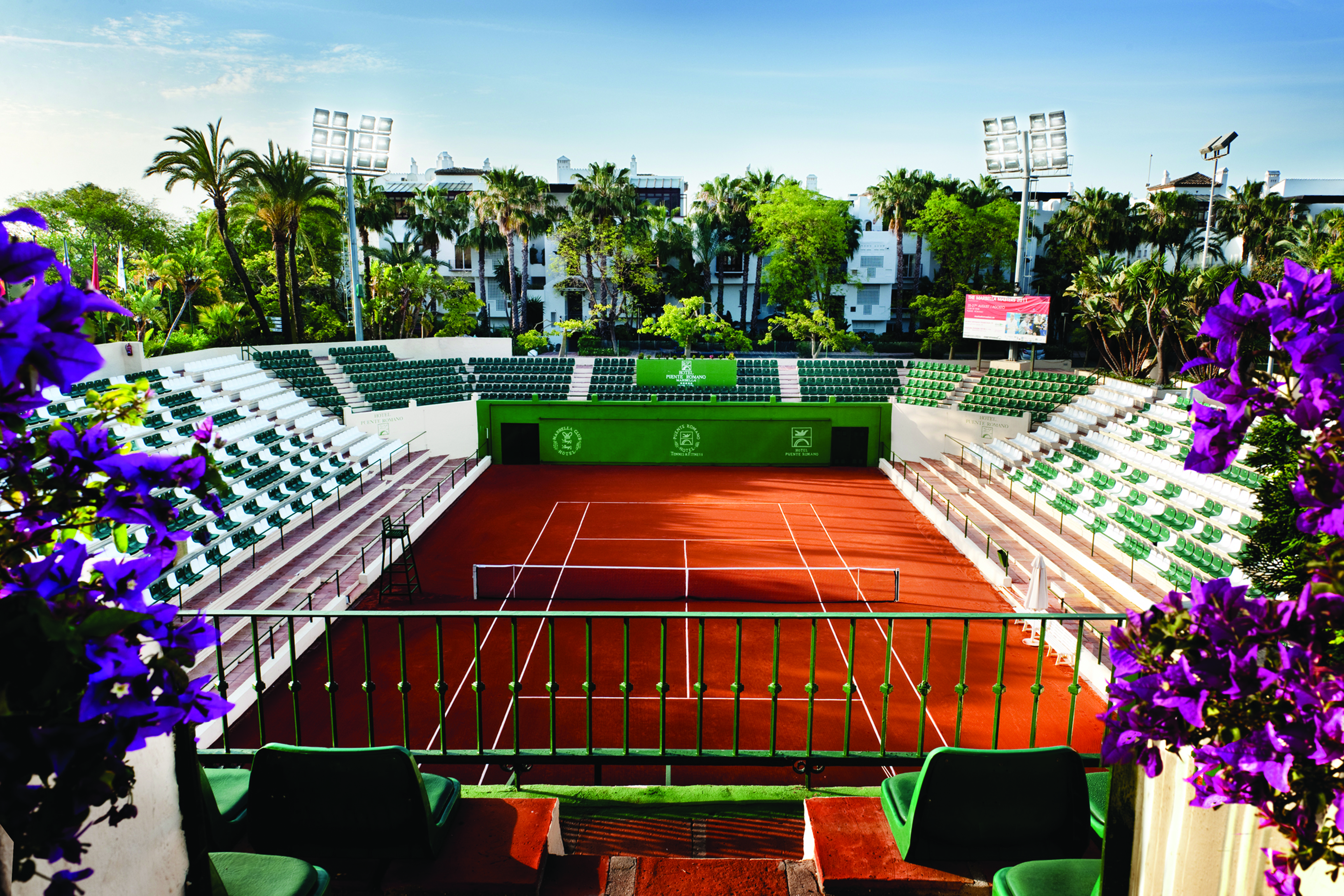 Hotel Puente Romano Marbella tennis court seating flowers