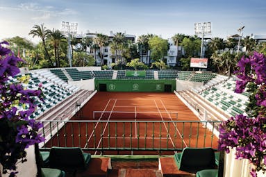 Hotel Puente Romano Marbella tennis court seating flowers