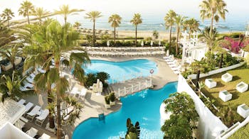 Puente Romano Marbella aerial shot of pools sun loungers beach in background