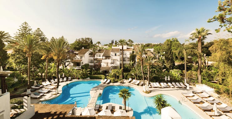Puente Romano Marbella pool sun loungers palm trees 