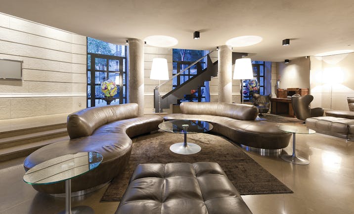 Hotel Claris Barcelona lobby leather sofas glass table stylish décor