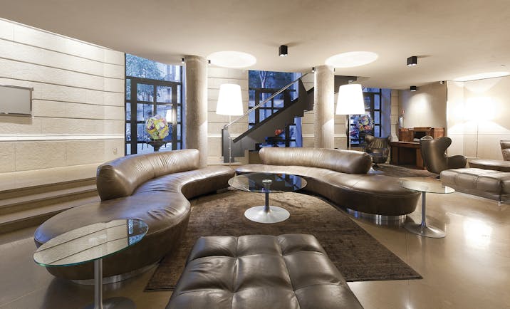 Hotel Claris Barcelona lobby leather sofas glass table stylish décor