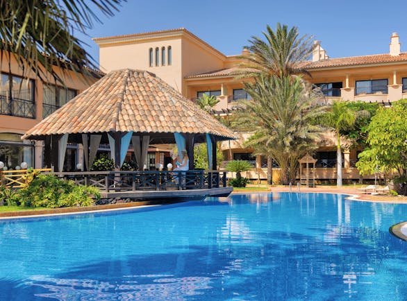 Gran Hotel Atlantis Bahia Fuerteventura pool side covered seating area palm trees