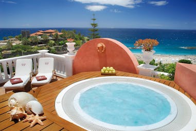 Jacuzzi terrace overlooking the sea with sun lougers  