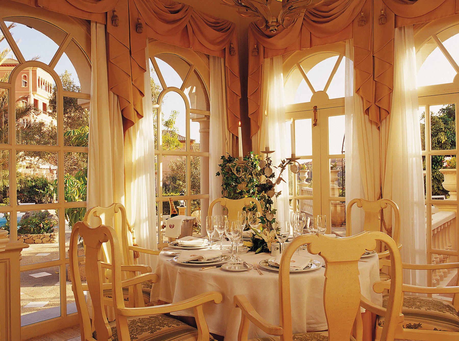 Indoor restaurant with gold colour scheme and draping curtains