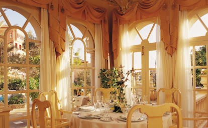 Indoor restaurant with gold colour scheme and draping curtains