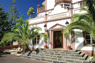 Gran Hotel Bahia Del Duque Tenerife terrace restaurant white building with columns steps and palm trees