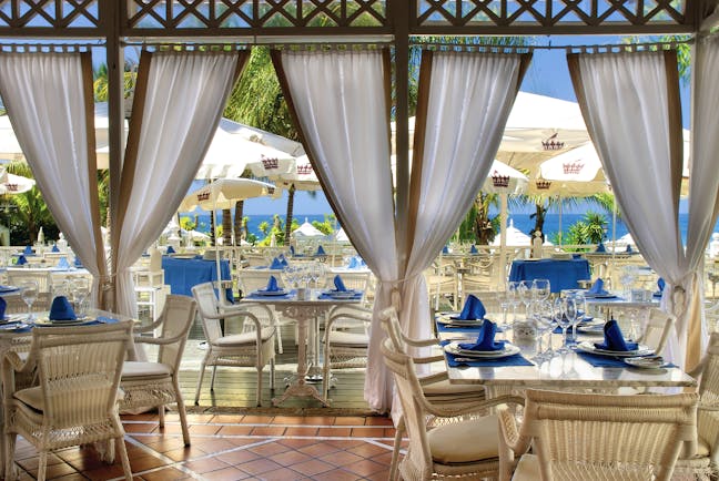 Gran Hotel Bahia Del Duque Tenerife restaurant with indoor and outdoor dining area and sea view