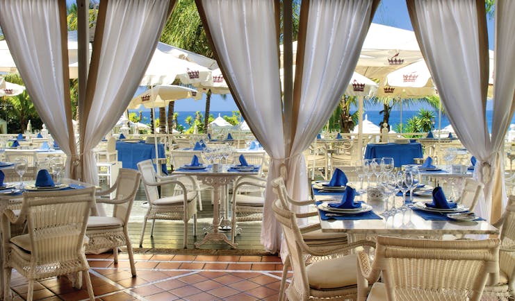 Gran Hotel Bahia Del Duque Tenerife restaurant with indoor and outdoor dining area and sea view