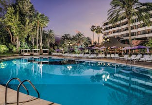 Hotel Botanico Tenerife exterior pool sun loungers hotel in background