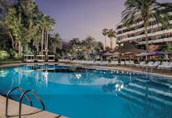 Hotel Botanico Tenerife exterior pool sun loungers hotel in background