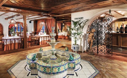 Hotel Botanico Tenerife La Parrilla restaurant indoor dining rustic décor water feature