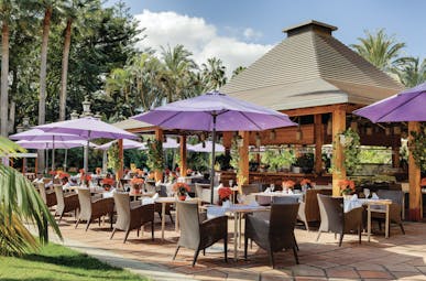 Hotel Botanico Tenerife Palmera Real restaurant outdoor dining umbrellas trees