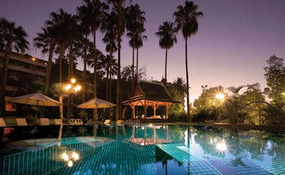 Hotel Botanico Tenerife pool night umbrellas trees hotel in background