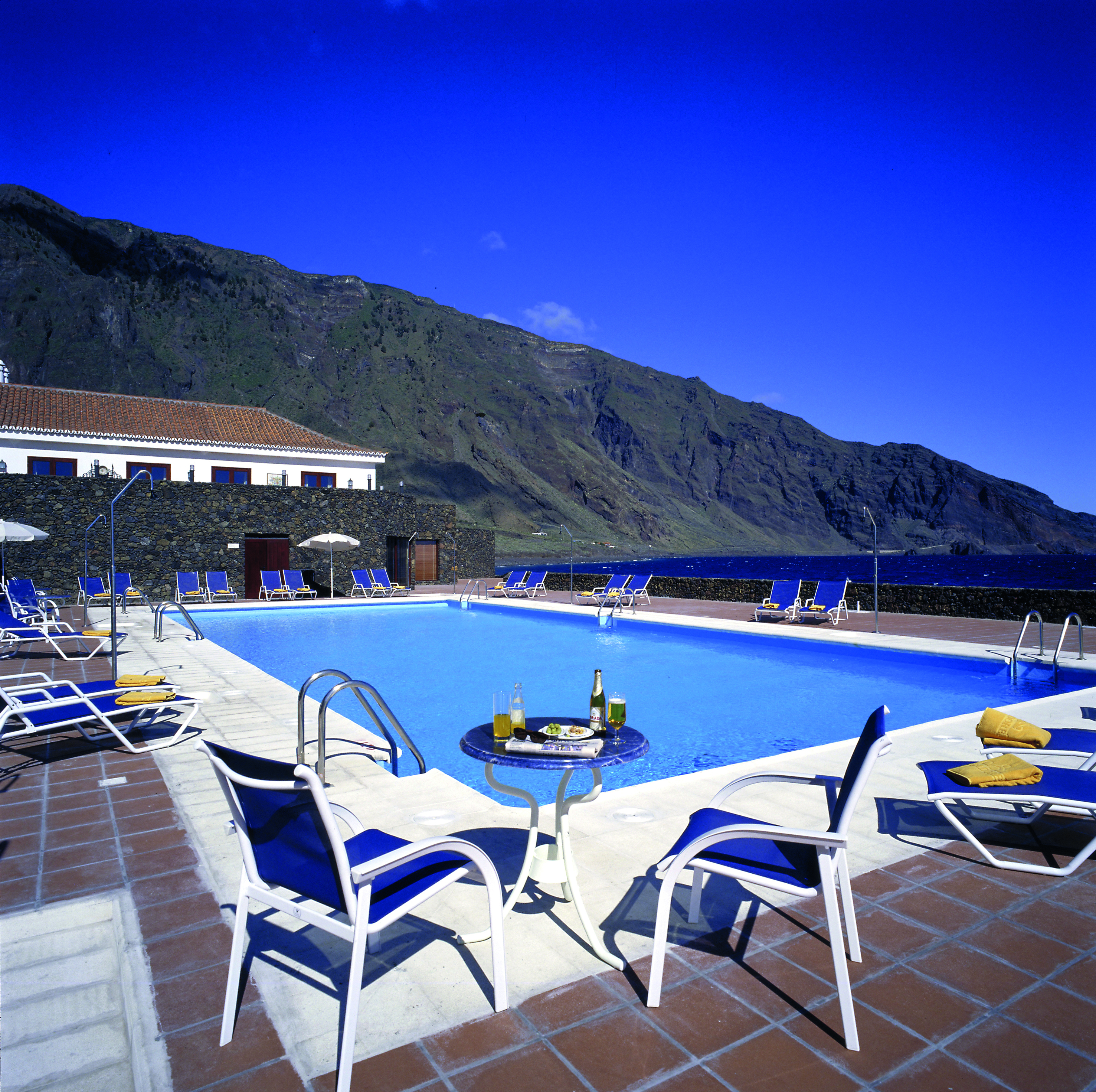 Parador de el Hierro Canary Islands pool sun loungers overlooking beach mountains in background