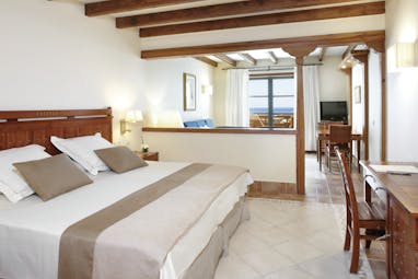 Princesa Yaiza junior suite, double bed, living area, bright modern decor, balcony with sea view