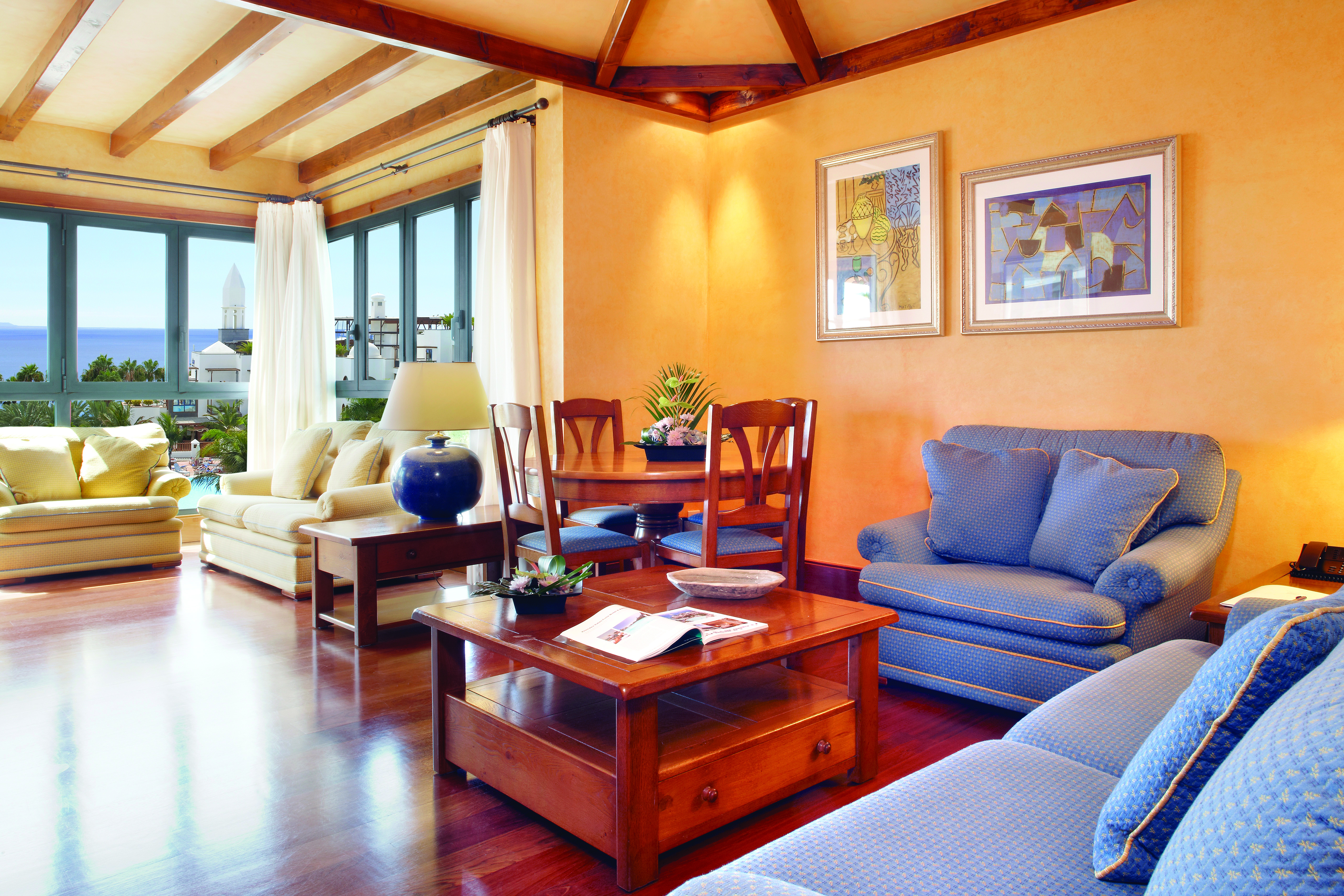 Princesa Yaiza presidential suite living room, modern decor, sofas and armchairs, large windows with views out to sea