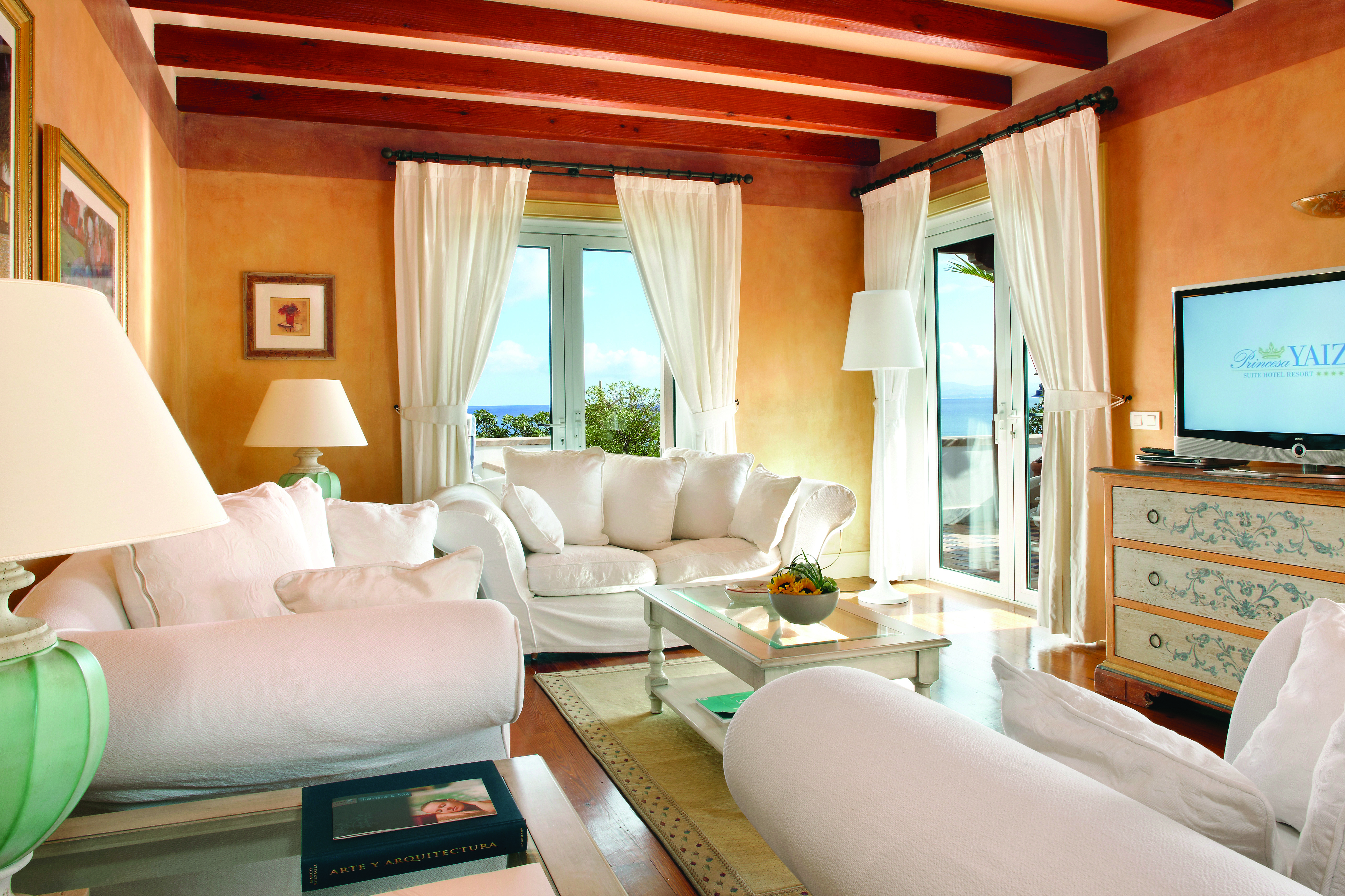 Princesa Yaiza royal suite living room, white sofas, fresh decor, exposed beams, balconies with sea view