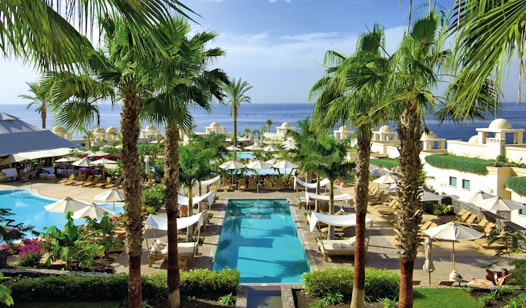 La Plantacion del Sur Tenerife pools sun loungers palm trees sea in background
