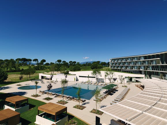 Hotel Camiral hotel grounds, pool, pool decking, gardens and lawns, mountains in background