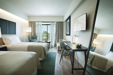 Hotel Camiral superior twin room, two beds, access to private balcony, elegant modern decor