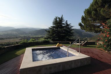 Hotel el Castell de Ciutat Catalonia hot tub outdoor terrace views of mountains and countryside