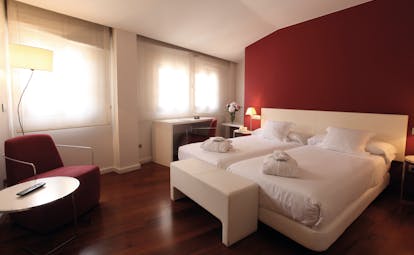 Gran Claustre Eastern Spain bedroom with red colour scheme and wide windows