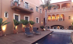 Gran Claustre Eastern Spain exterior pool sun loungers balcony potted plants