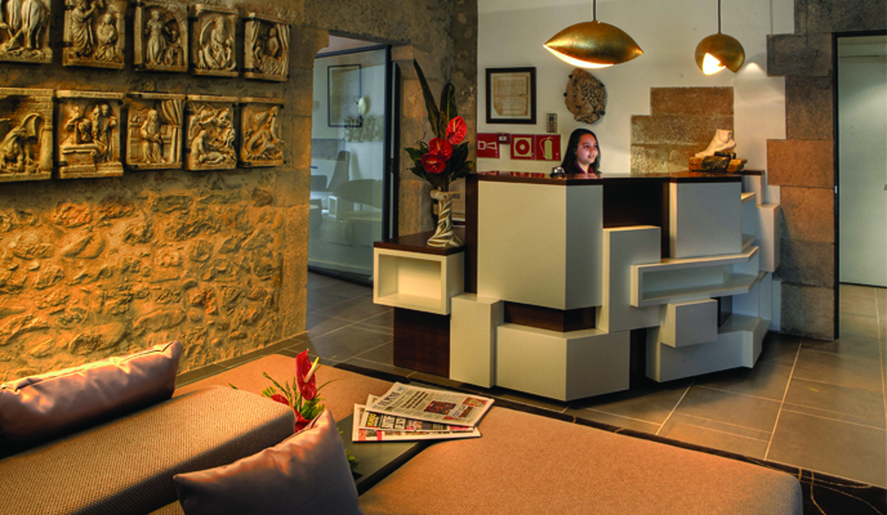 Hotel Llegendes de Girona Eastern Spain lobby desk sofas stone walls modern décor